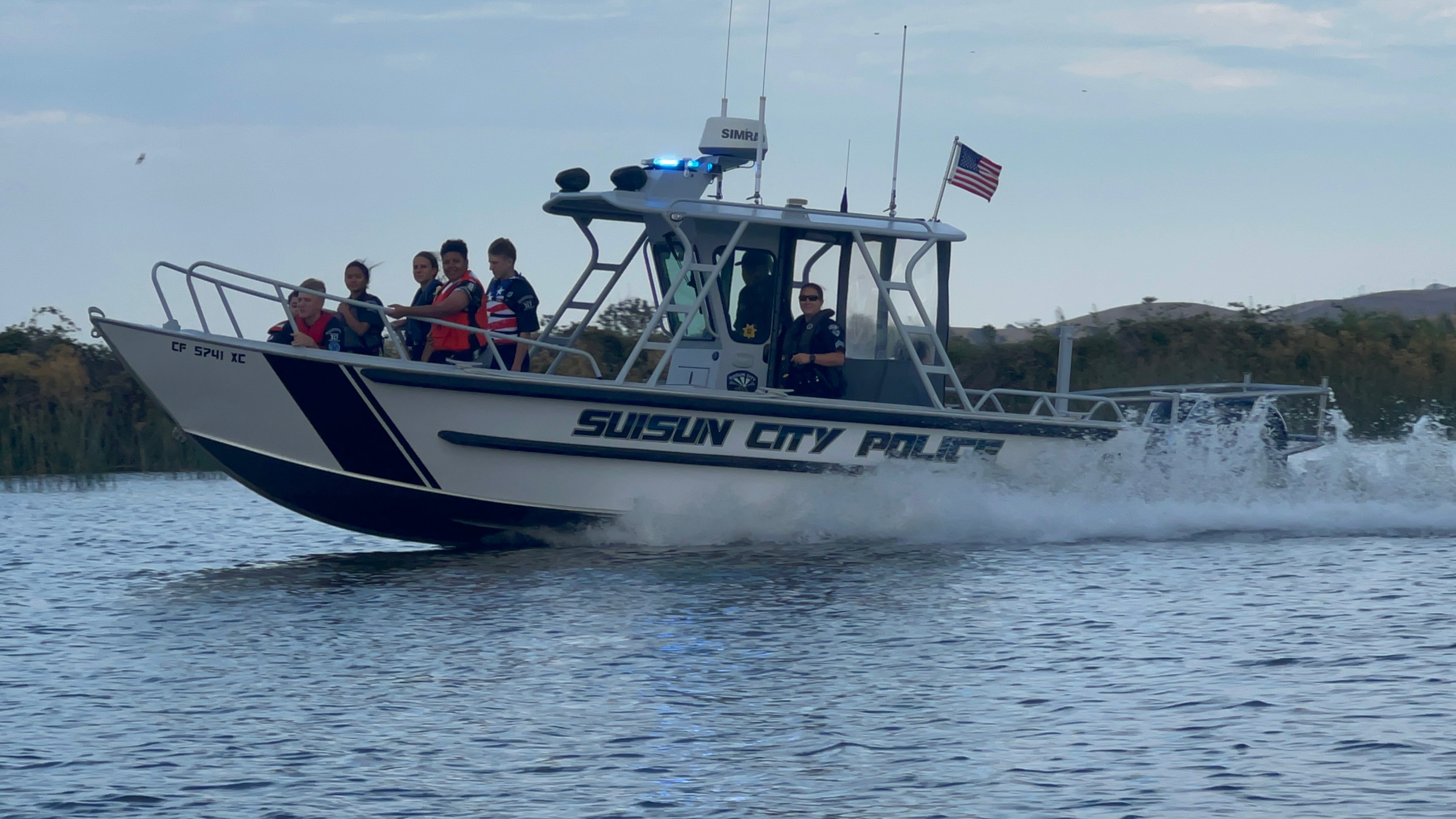 The Suisun City Police Dept Boat on the water with the Officers on board. 
